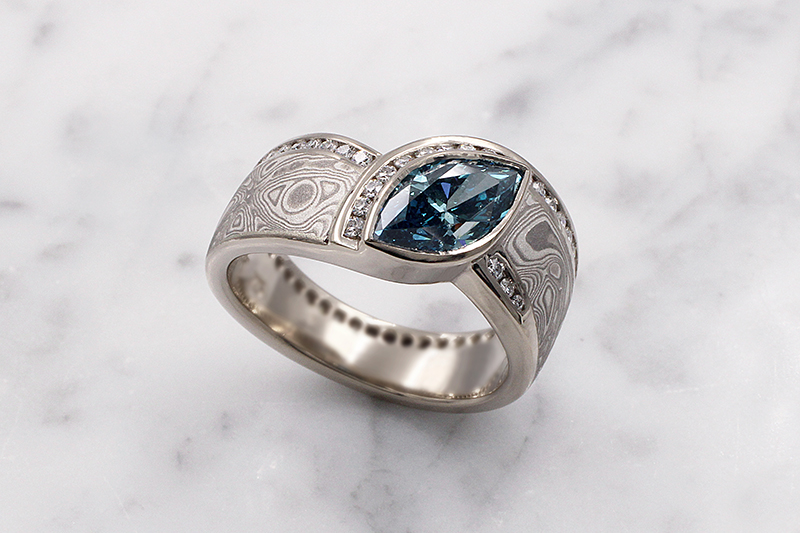 Mokume Wave Diamond Crossing Engagement Ring With Blue Diamond