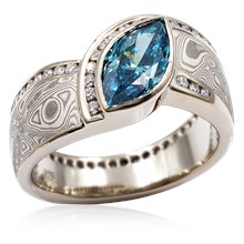 Mokume Wave Diamond Crossing Engagement Ring with blue diamond