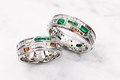 Shown in platinum with emerald, diamond, and spessartite accent stones. 