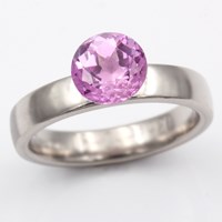 Pink sapphire with white metal band