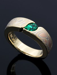 Mokume Wave Engagement Ring with Pear Cut Lab Emerald Solitaire